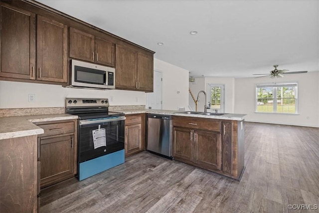 11325 Webb Rd, Disputanta, VA 23842 - kitchen featuring appliances with stainless steel finishes, a peninsula, dark wood-type flooring, light countertops, and ceiling fan