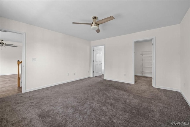 11325 Webb Rd, Disputanta, VA 23842 - unfurnished bedroom featuring dark carpet, a spacious closet, and ceiling fan