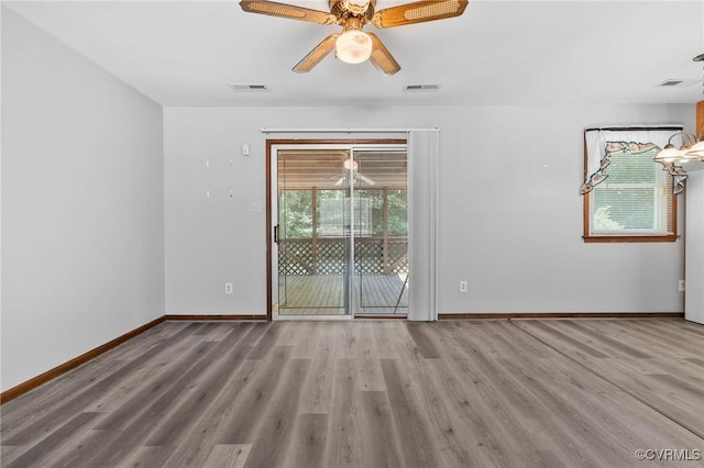 11900 James River Dr, North Prince George, VA 23860 - empty room featuring wood finished floors, healthy amount of natural light, and a ceiling fan