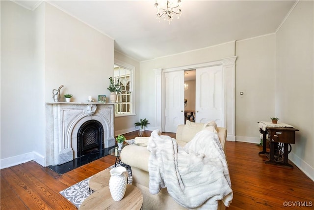 544 High St, Petersburg, VA 23803 - living area featuring hardwood / wood-style flooring, a fireplace with flush hearth, a chandelier, and crown molding