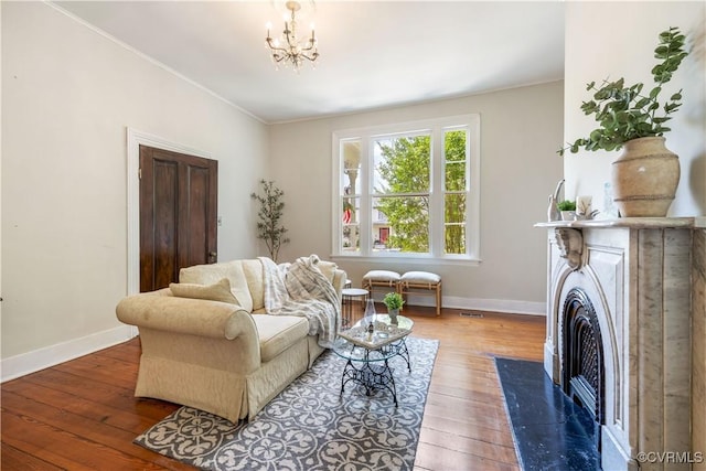 544 High St, Petersburg, VA 23803 - living area featuring hardwood / wood-style floors, a chandelier, crown molding, and a fireplace with flush hearth