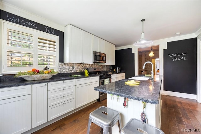 544 High St, Petersburg, VA 23803 - kitchen with appliances with stainless steel finishes, ornamental molding, dark countertops, and dark wood finished floors