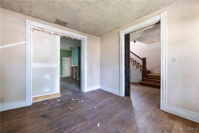 415 W 24th St, Richmond, VA 23225 - spare room with hardwood / wood-style flooring, a textured ceiling, and stairs