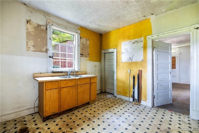 415 W 24th St, Richmond, VA 23225 - kitchen with light floors, light countertops, brown cabinets, and a textured ceiling