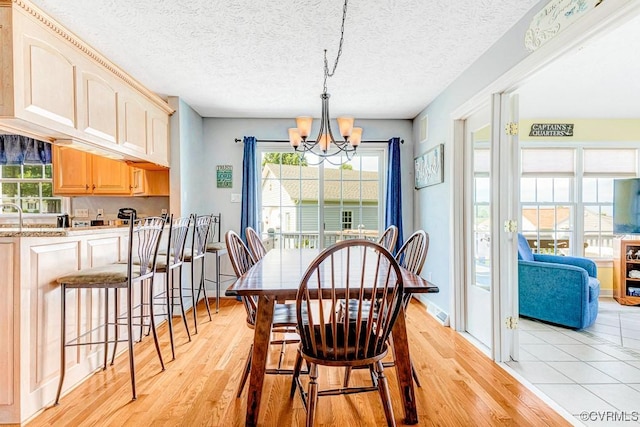 1382 Glebe Landing Rd, Center Cross, VA 22437 - dining area featuring a chandelier and light wood-type flooring