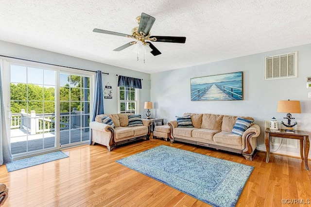 1382 Glebe Landing Rd, Center Cross, VA 22437 - living room featuring a textured ceiling, light wood finished floors, and ceiling fan