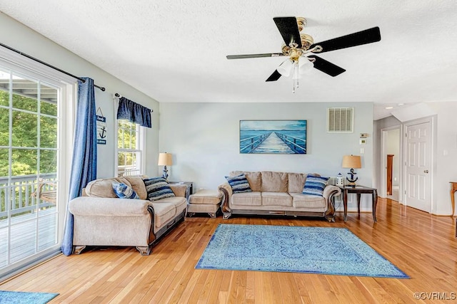 1382 Glebe Landing Rd, Center Cross, VA 22437 - living room featuring wood finished floors, a textured ceiling, and a ceiling fan
