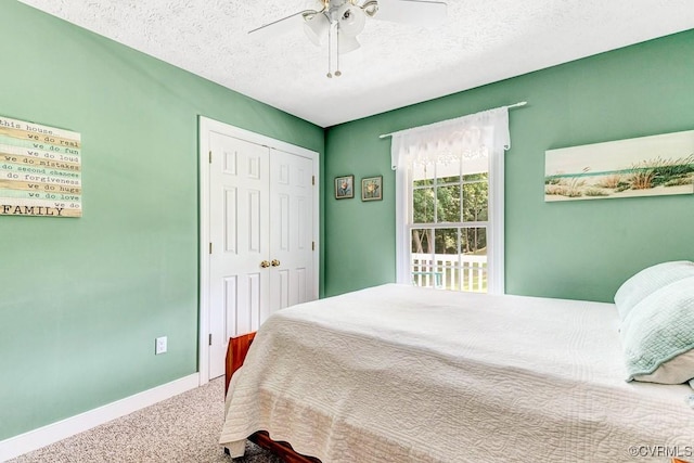 1382 Glebe Landing Rd, Center Cross, VA 22437 - bedroom with carpet, a closet, a textured ceiling, and ceiling fan