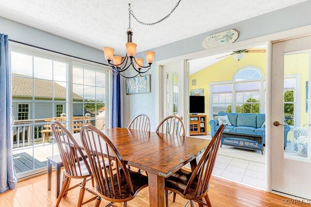1382 Glebe Landing Rd, Center Cross, VA 22437 - dining room featuring a chandelier, light wood finished floors, and a textured ceiling