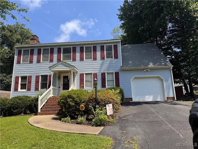 11906 Exbury Ter, Midlothian, VA 23114 - colonial-style house featuring a garage, a chimney, driveway, and a front lawn