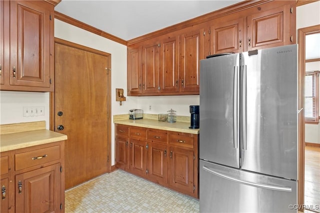 11906 Exbury Ter, Midlothian, VA 23114 - kitchen with freestanding refrigerator, brown cabinets, and light countertops