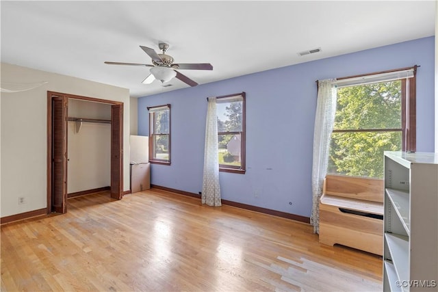 11906 Exbury Ter, Midlothian, VA 23114 - unfurnished bedroom featuring multiple windows, light wood-style floors, and a closet