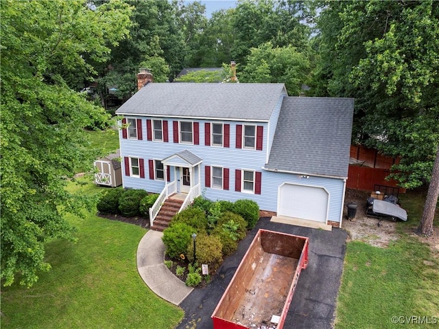 11906 Exbury Ter, Midlothian, VA 23114 - colonial home featuring roof with shingles, asphalt driveway, a chimney, and a garage
