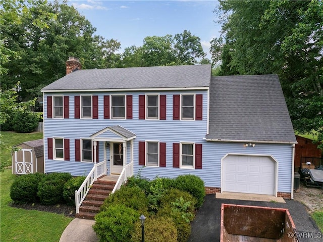 11906 Exbury Ter, Midlothian, VA 23114 - colonial house with a storage shed, asphalt driveway, a chimney, a shingled roof, and an attached garage