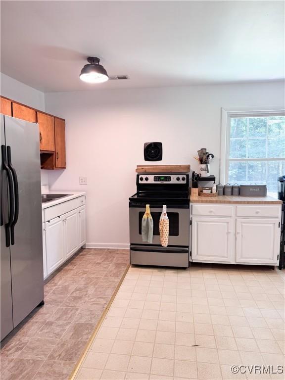 3601 Haupts Ln, Charles City, VA 23231 - kitchen with appliances with stainless steel finishes, light countertops, and white cabinetry