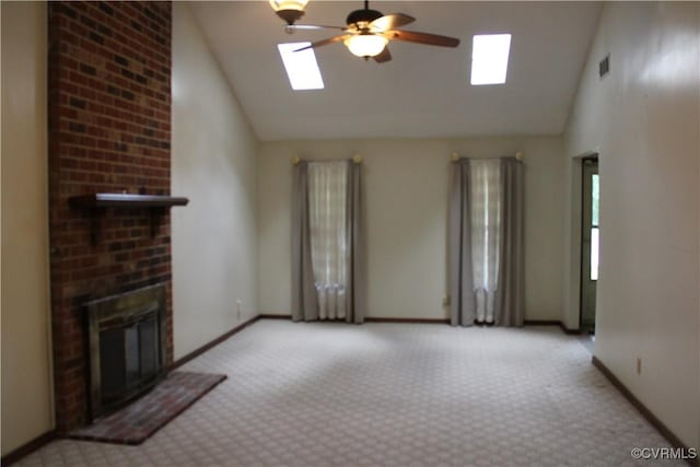 7401 Velvet Antler Dr, Midlothian, VA 23112 - unfurnished living room featuring a skylight, high vaulted ceiling, light carpet, a ceiling fan, and a fireplace