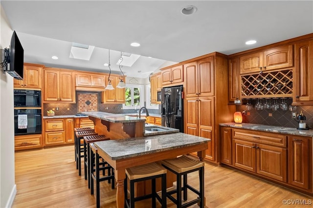 18030 W County Line Rd, Midlothian, VA 23112 - kitchen with black refrigerator with ice dispenser, decorative backsplash, dark stone countertops, a breakfast bar, and light wood finished floors