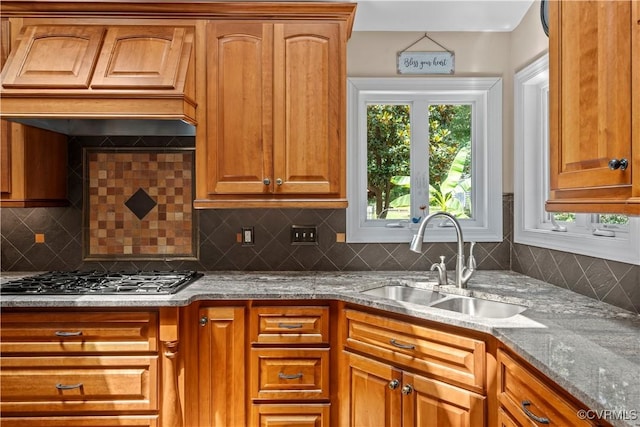 18030 W County Line Rd, Midlothian, VA 23112 - kitchen featuring stainless steel gas stovetop, custom exhaust hood, light stone countertops, and brown cabinetry