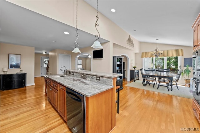 18030 W County Line Rd, Midlothian, VA 23112 - kitchen featuring light wood finished floors, a breakfast bar area, a kitchen island with sink, lofted ceiling, and a chandelier
