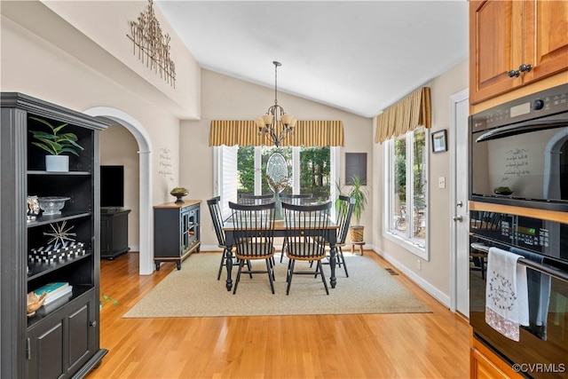 18030 W County Line Rd, Midlothian, VA 23112 - dining space with light wood-style flooring, a chandelier, vaulted ceiling, and arched walkways