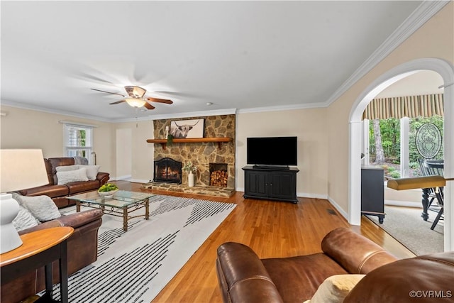 18030 W County Line Rd, Midlothian, VA 23112 - living room featuring wood finished floors, ceiling fan, ornamental molding, a fireplace, and arched walkways