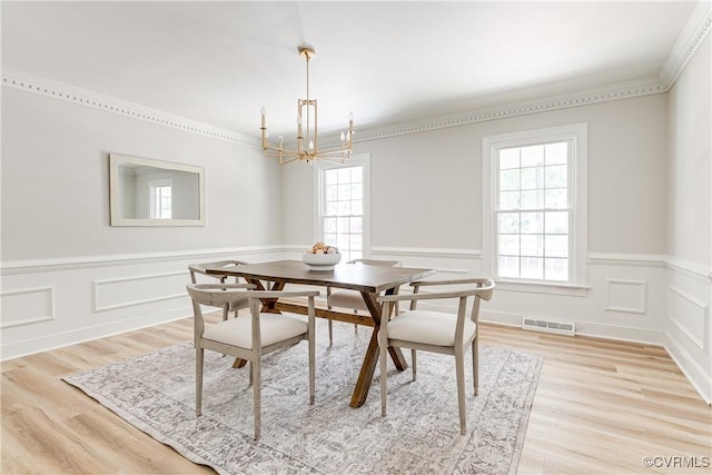 2613 Teaberry Dr, North Chesterfield, VA 23236 - dining area with a chandelier, a wainscoted wall, ornamental molding, light wood-style floors, and a decorative wall