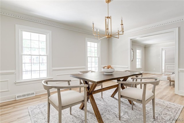 2613 Teaberry Dr, North Chesterfield, VA 23236 - dining room featuring plenty of natural light, a chandelier, a wainscoted wall, a decorative wall, and light wood-type flooring