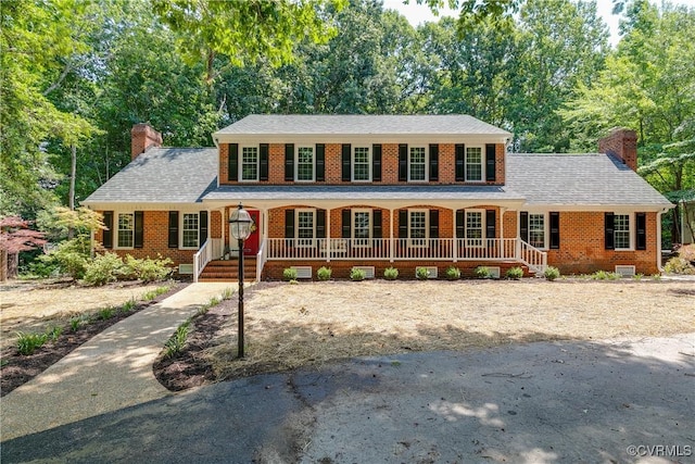2613 Teaberry Dr, North Chesterfield, VA 23236 - colonial home featuring a chimney, a porch, and brick siding
