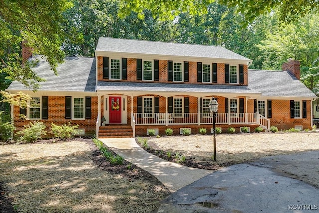 2613 Teaberry Dr, North Chesterfield, VA 23236 - colonial-style house with a chimney, a porch, and brick siding