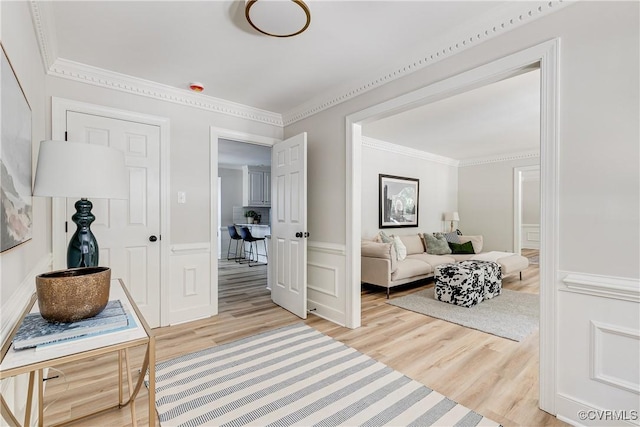 2613 Teaberry Dr, North Chesterfield, VA 23236 - living area with light wood-type flooring, crown molding, a wainscoted wall, and a decorative wall