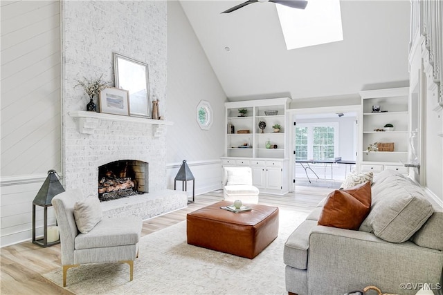 2613 Teaberry Dr, North Chesterfield, VA 23236 - living area featuring high vaulted ceiling, light wood-style floors, ceiling fan, a brick fireplace, and a skylight