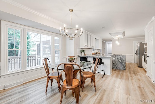 2613 Teaberry Dr, North Chesterfield, VA 23236 - dining area featuring crown molding, light wood-type flooring, a chandelier, and wainscoting