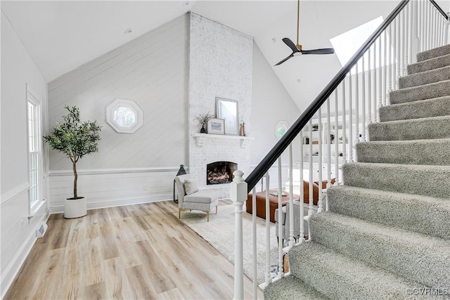 2613 Teaberry Dr, North Chesterfield, VA 23236 - stairway with high vaulted ceiling, a fireplace, wood finished floors, a ceiling fan, and wooden walls