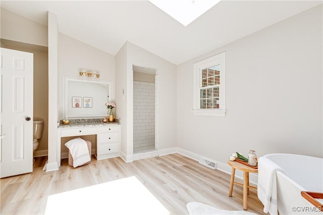 2613 Teaberry Dr, North Chesterfield, VA 23236 - bathroom featuring a soaking tub, wood finished floors, vaulted ceiling, tiled shower, and vanity
