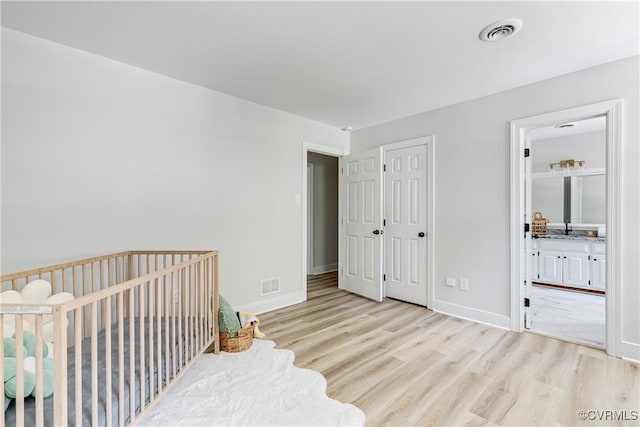 2613 Teaberry Dr, North Chesterfield, VA 23236 - bedroom featuring light wood-type flooring, connected bathroom, and a closet