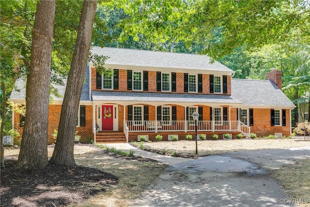 2613 Teaberry Dr, North Chesterfield, VA 23236 - colonial house with a porch, a chimney, and brick siding
