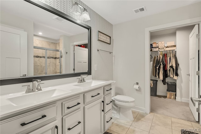5845 Austin Woods Dr, North Chesterfield, VA 23234 - full bath featuring double vanity, a shower stall, wallpapered walls, tile patterned floors, and a spacious closet