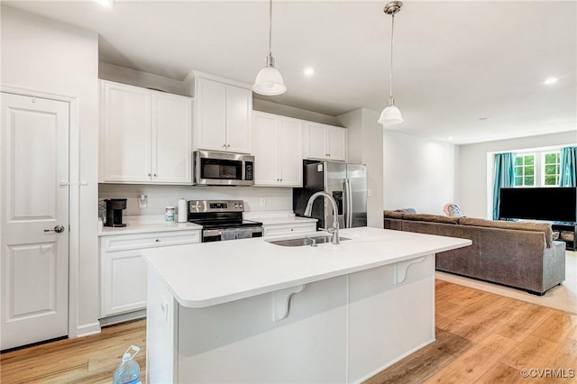 3119 Perdue Springs Dr, Chester, VA 23831 - kitchen with stainless steel appliances, open floor plan, white cabinets, light wood finished floors, and recessed lighting