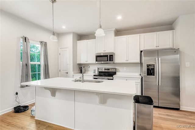 3119 Perdue Springs Dr, Chester, VA 23831 - kitchen with appliances with stainless steel finishes, light wood finished floors, white cabinetry, a kitchen breakfast bar, and light countertops