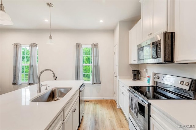 3119 Perdue Springs Dr, Chester, VA 23831 - kitchen with stainless steel appliances, light wood-style flooring, light countertops, hanging light fixtures, and recessed lighting