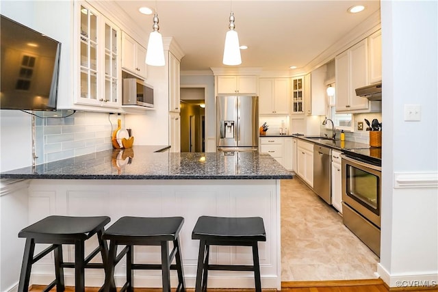 5618 Buxton Ct, Chester, VA 23831 - kitchen featuring appliances with stainless steel finishes, a peninsula, decorative light fixtures, recessed lighting, and backsplash