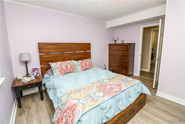 5618 Buxton Ct, Chester, VA 23831 - bedroom featuring light wood finished floors, a textured ceiling, washer / clothes dryer, and ornamental molding