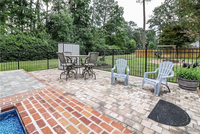 5618 Buxton Ct, Chester, VA 23831 - fenced backyard with a patio, outdoor dining space, a shed, and view of wooded area
