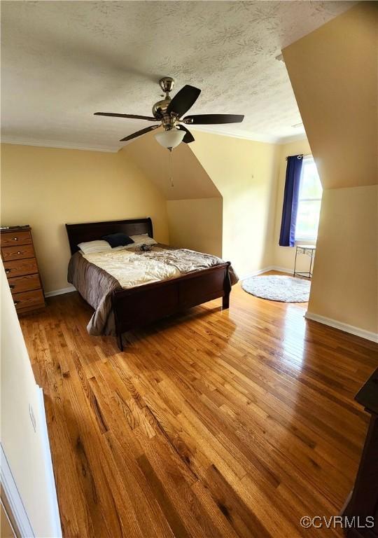 1932 Howardsville Tpke, Stuarts Draft, VA 24477 - bedroom with wood finished floors, lofted ceiling, a ceiling fan, a textured ceiling, and crown molding