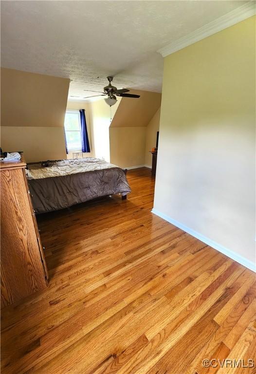 1932 Howardsville Tpke, Stuarts Draft, VA 24477 - bedroom with light wood-style flooring, ornamental molding, vaulted ceiling, and ceiling fan