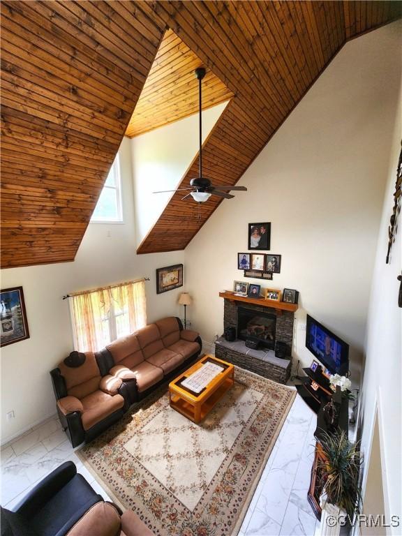 1932 Howardsville Tpke, Stuarts Draft, VA 24477 - living room with marble look tile flooring, wood ceiling, high vaulted ceiling, a ceiling fan, and a stone fireplace