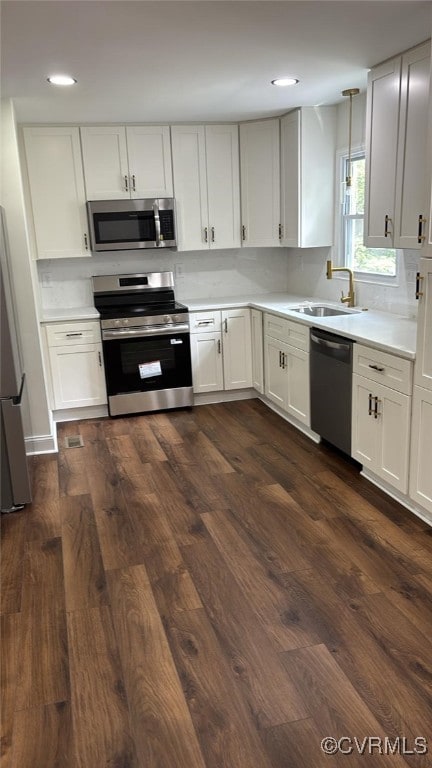 8057 Hermitage Rd, Henrico, VA 23228 - kitchen featuring appliances with stainless steel finishes, dark wood-type flooring, light countertops, recessed lighting, and white cabinets