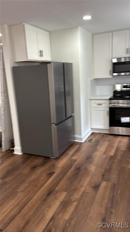 8057 Hermitage Rd, Henrico, VA 23228 - kitchen with appliances with stainless steel finishes, white cabinetry, dark wood-style floors, light countertops, and recessed lighting