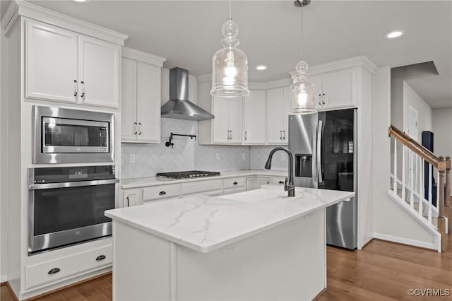 3391 Rock Creek Villa Dr, Quinton, VA 23141 - kitchen featuring appliances with stainless steel finishes, wall chimney exhaust hood, wood finished floors, backsplash, and recessed lighting
