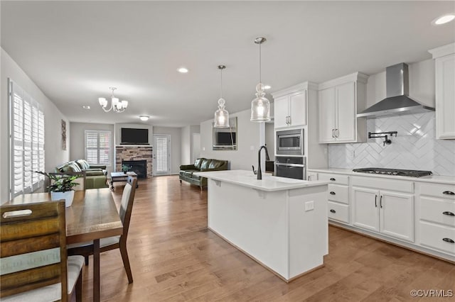 3391 Rock Creek Villa Dr, Quinton, VA 23141 - kitchen featuring wall chimney exhaust hood, appliances with stainless steel finishes, backsplash, light countertops, and white cabinetry